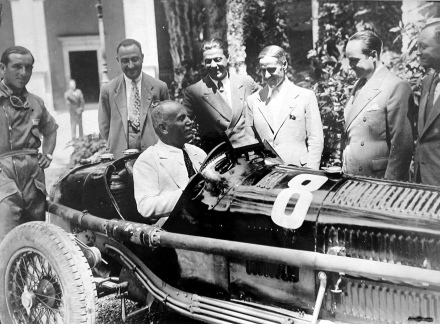 Mussolini in the hotseat as he greets Tazio Nuvoleri (centre) and the Alfa team